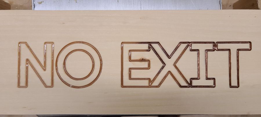 A laser-cut wooden sign reading No Exit