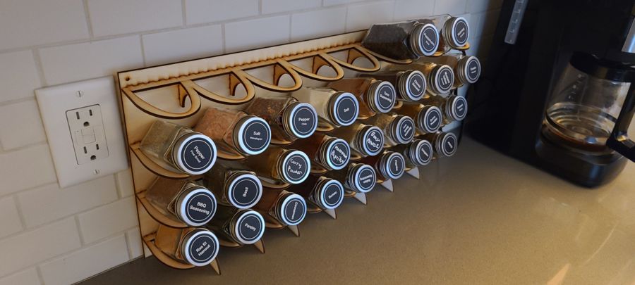 A wooden spice rack with laser-cut labels