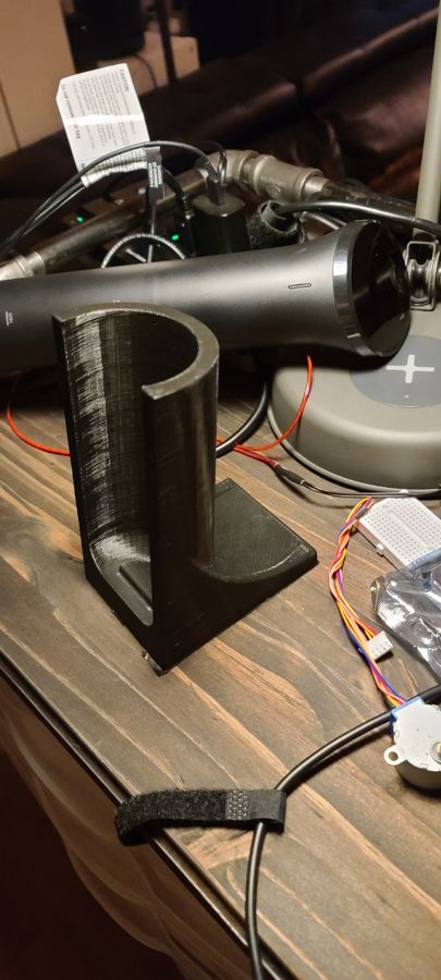 A 3D-printed stand holding a sous vide cooker